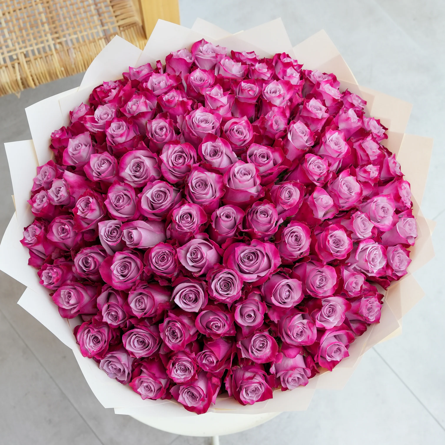 Bouquet of 100 purple roses Marbella arranged in white wrapping by Bloom Marbella