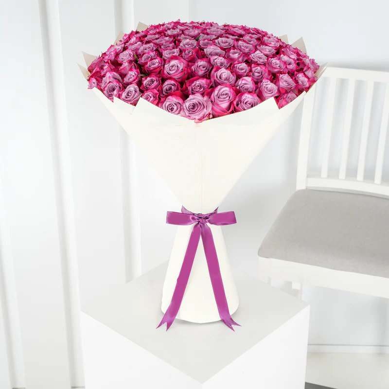 Bouquet of 100 purple roses Marbella wrapped in white paper with purple ribbon by Bloom Marbella
