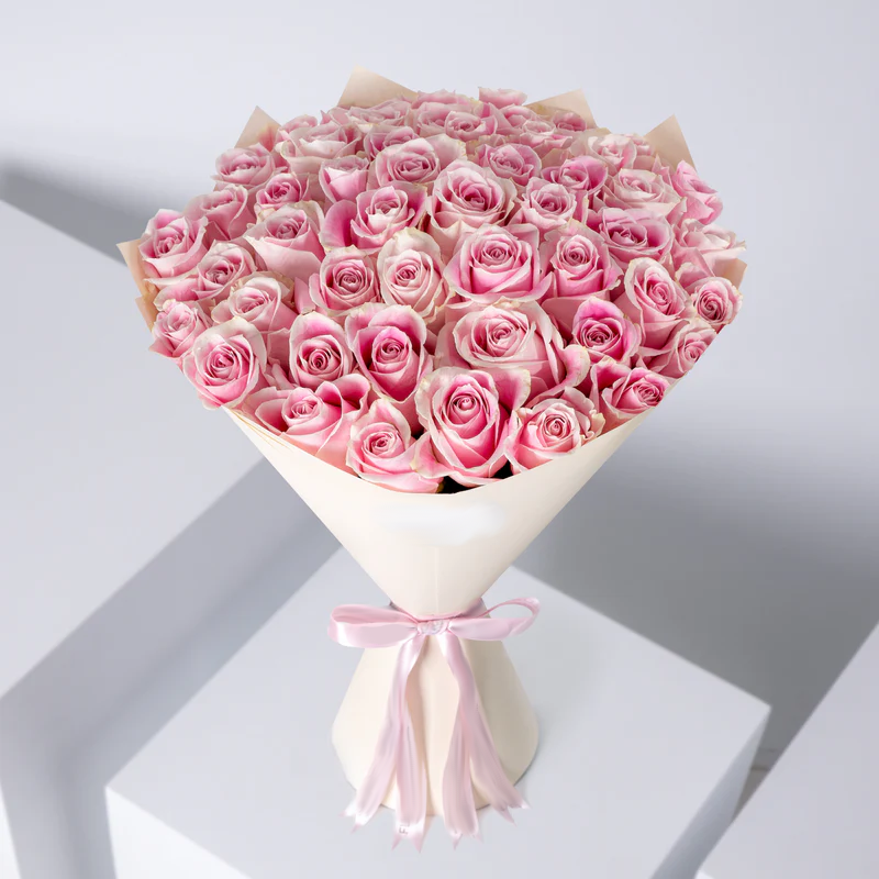 50 pink roses bouquet elegantly wrapped in cream paper with a soft pink ribbon bow