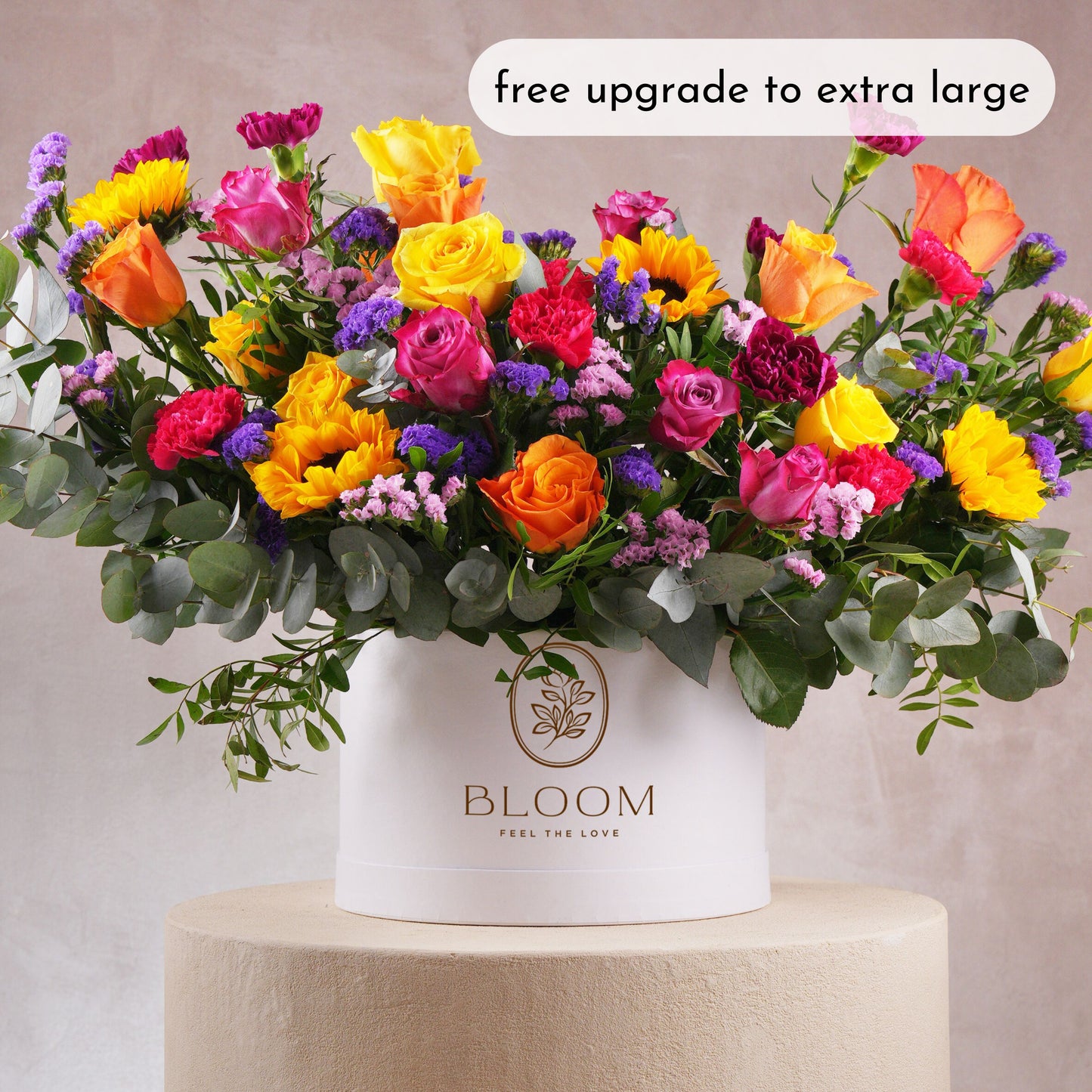 Luxury flower hatbox Marbella by Bloom Marbella with vibrant mixed roses and sunflowers in white round box