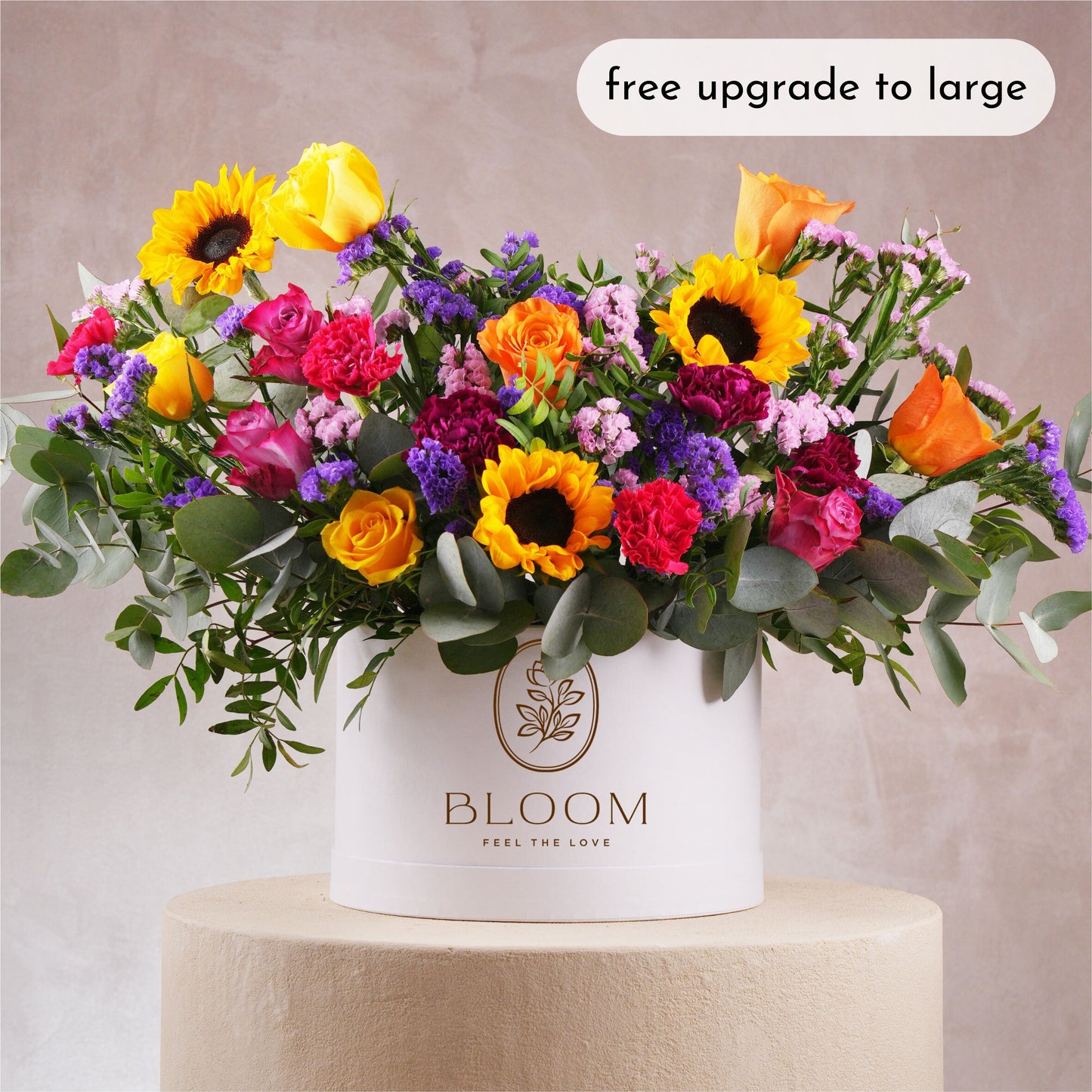 Luxury flower hatbox Marbella by Bloom Marbella with vibrant sunflowers roses and mixed blooms in white round box