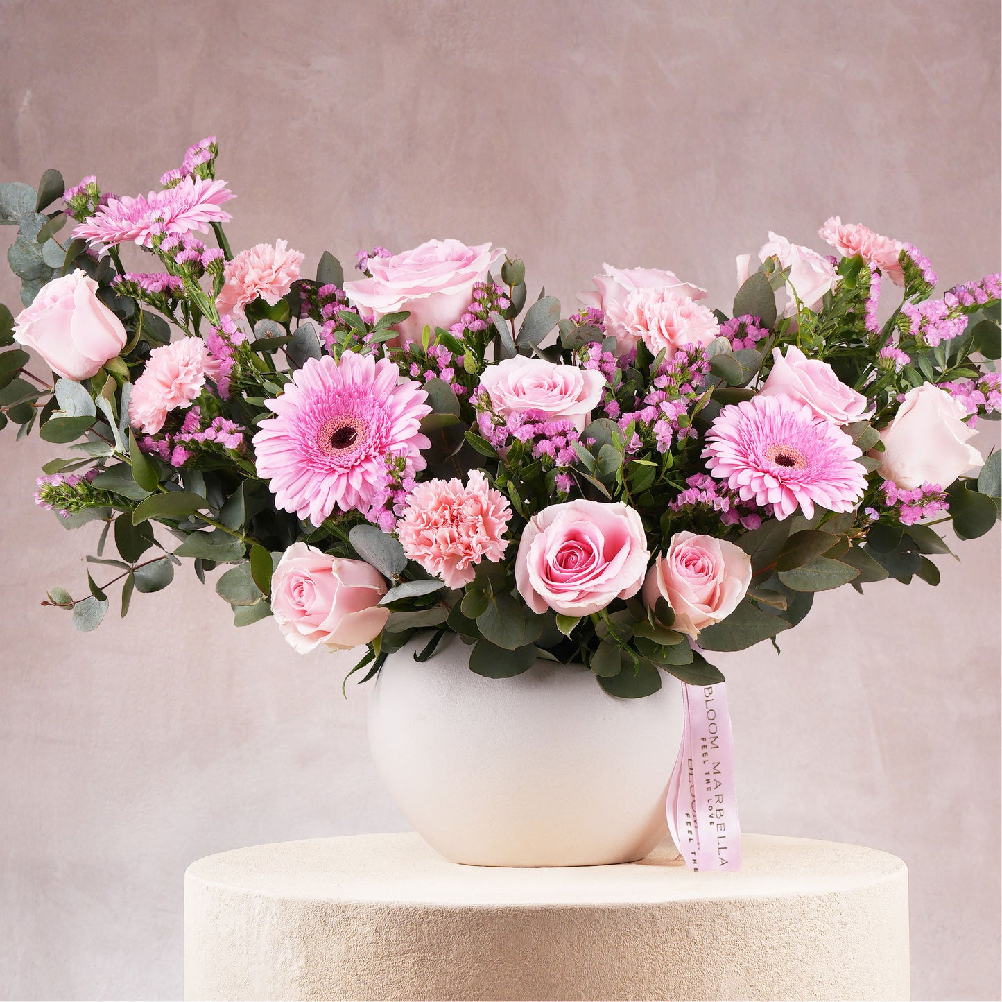 Elegant pink flower arrangement Marbella with roses, carnations, and greenery in white Bloom Marbella vase