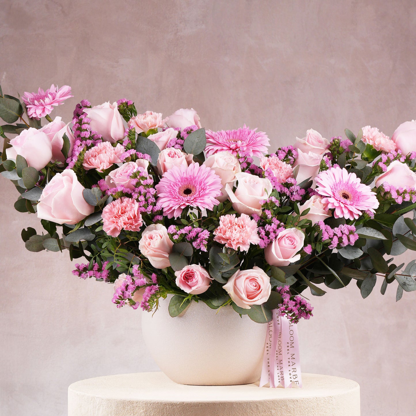 Elegant pink flower arrangement Marbella with roses, carnations, and greenery in a white vase