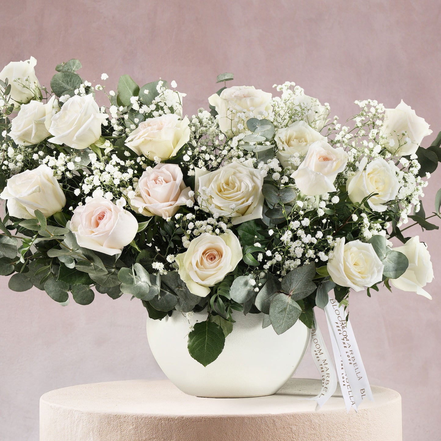 Modern luxury white flower vase Bloom Marbella Costa Del Sol Spain with white roses and greenery bouquet