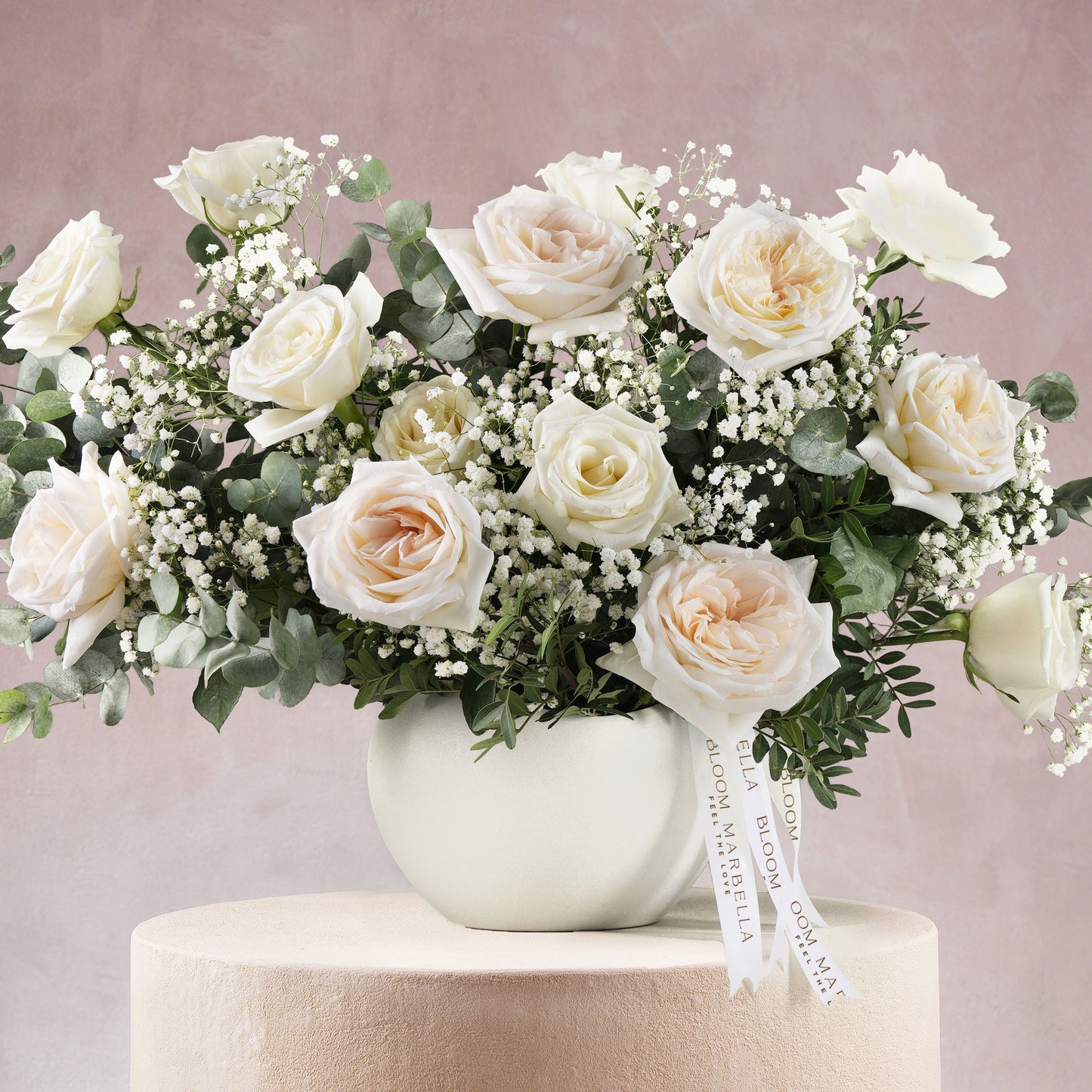 Modern luxury white flower vase Bloom Marbella Costa Del Sol Spain with white roses and greenery