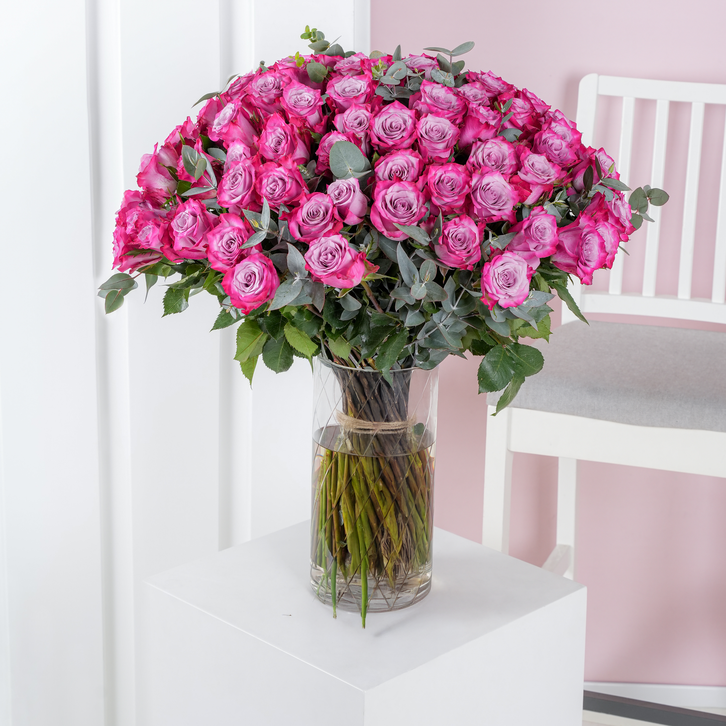 100 purple roses in vase - Bloom Marbella, Spain with lush green leaves in clear glass vase