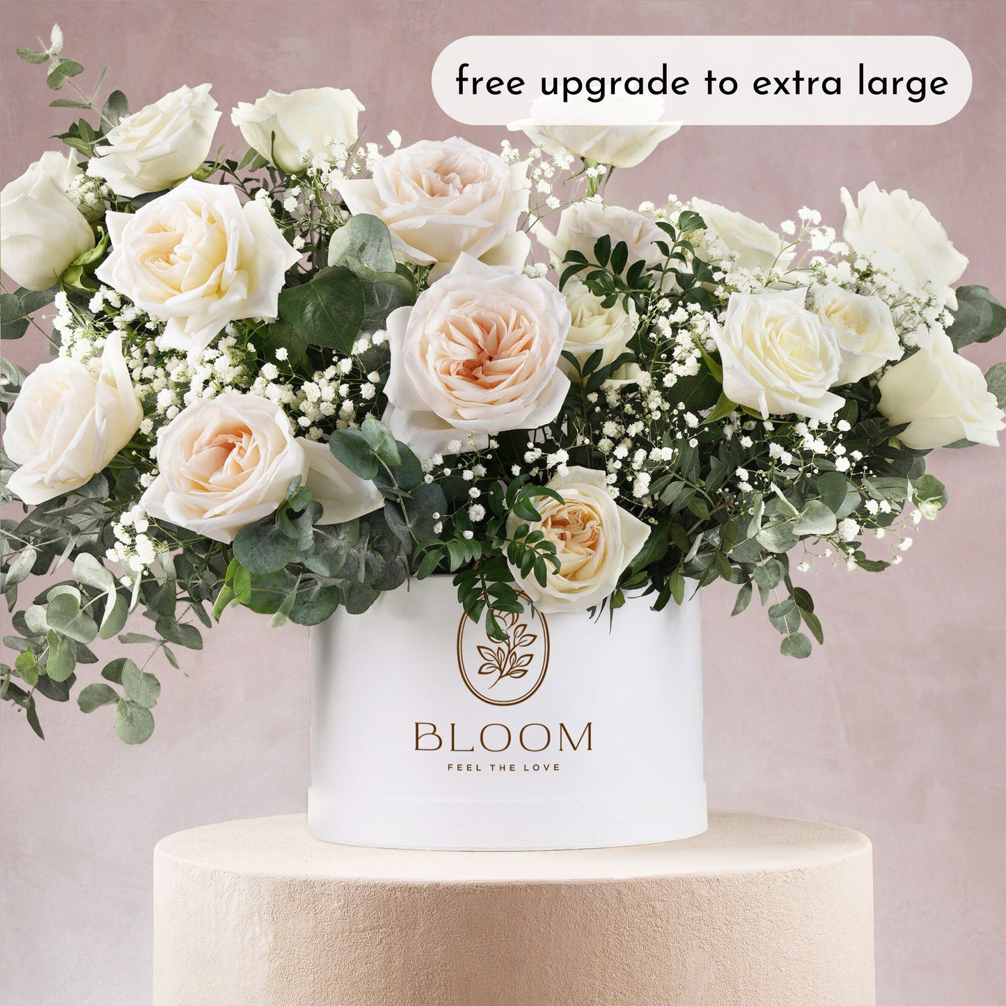 White hatbox flower arrangement Bloom Marbella with cream roses and greenery in white round box