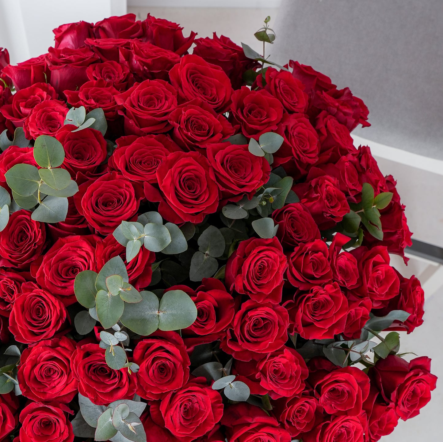 Bloom Marbella 200 red roses bouquet delivery with lush green foliage in a large elegant arrangement