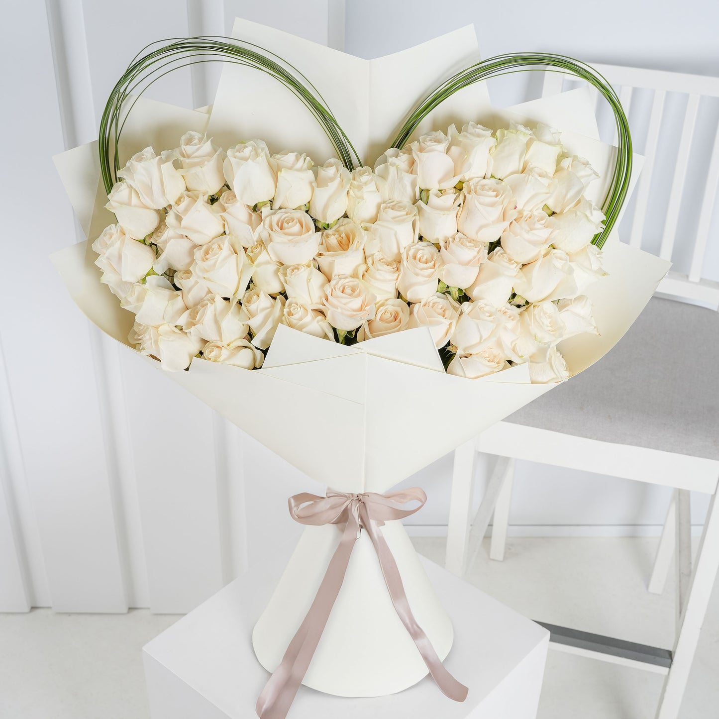 Luxury white rose bouquet Marbella arranged in a heart shape with decorative greenery and elegant wrapping
