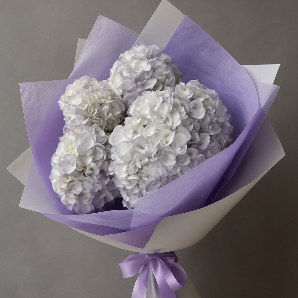 Purple hydrangea bouquet Marbella wrapped in purple and white paper with matching ribbon by Bloom Marbella