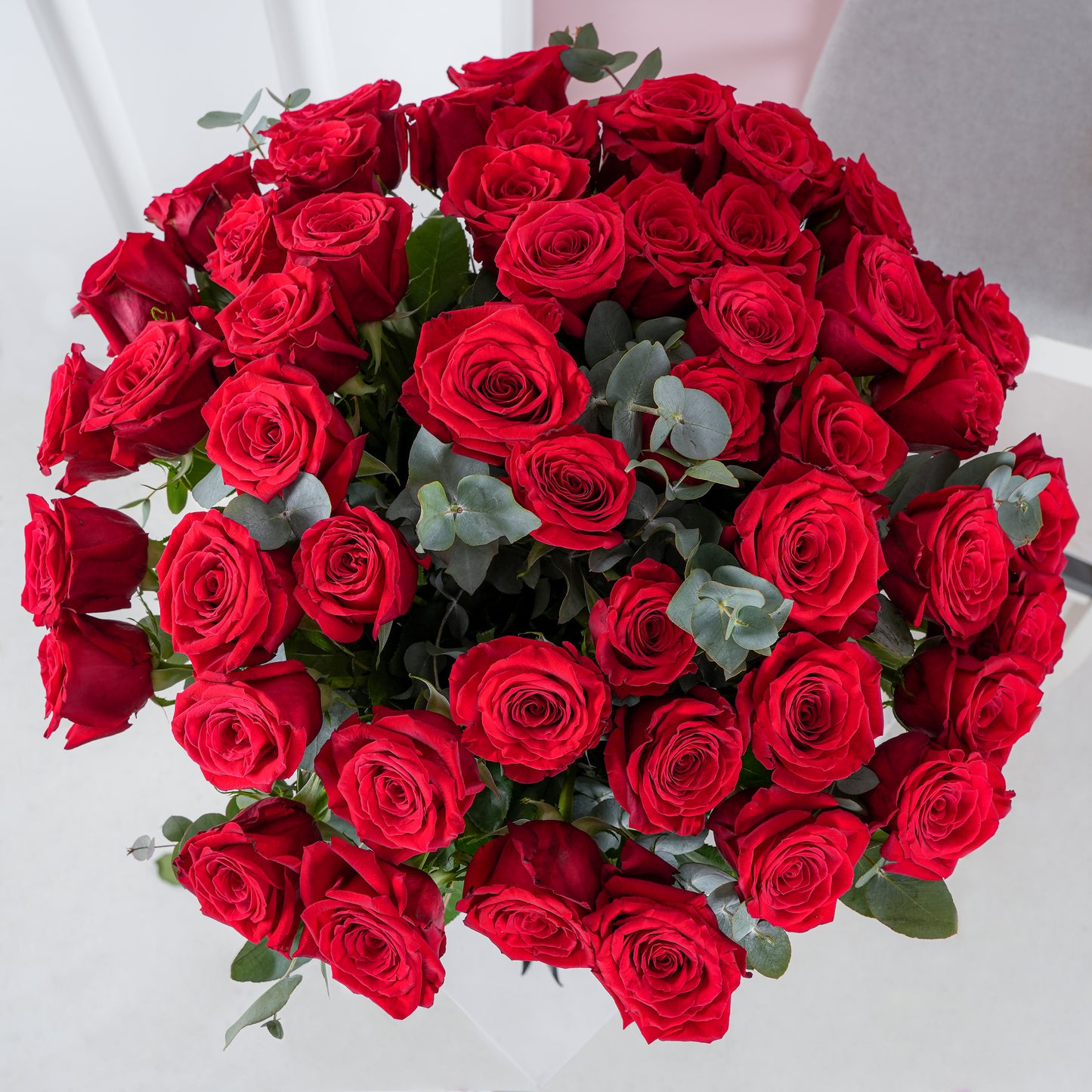 50 red roses in vase arranged with greenery from Bloom Marbella, vibrant fresh bouquet for special occasions