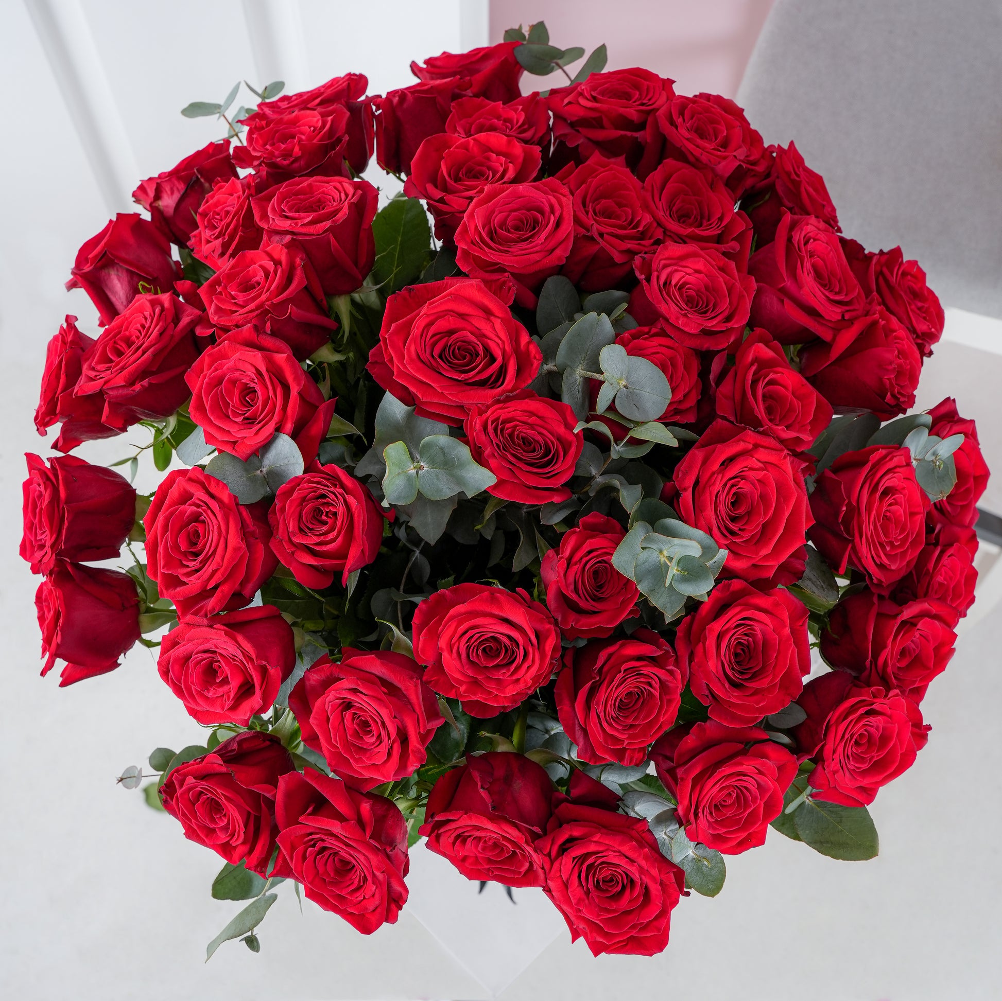 50 red roses in vase arranged with greenery from Bloom Marbella, vibrant fresh bouquet for special occasions