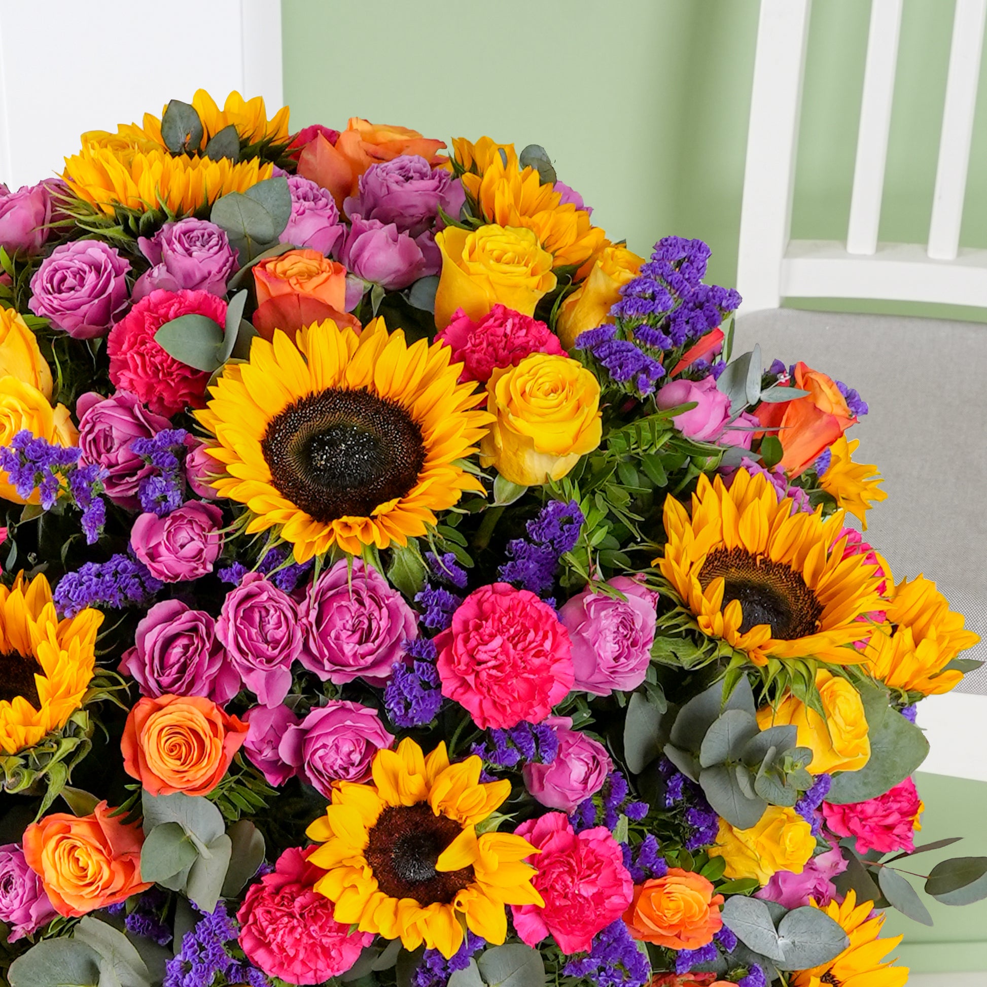 Luxury flower hatbox Marbella with vibrant sunflowers pink roses and orange blooms by Bloom Marbella