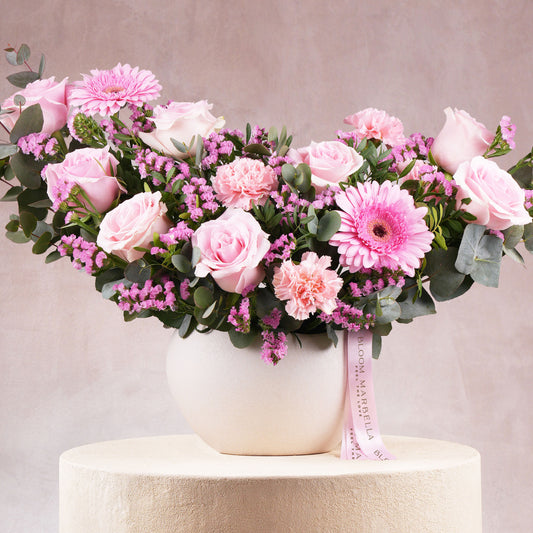 Pink flower arrangement Marbella with roses carnations and greenery in white vase by Bloom Marbella