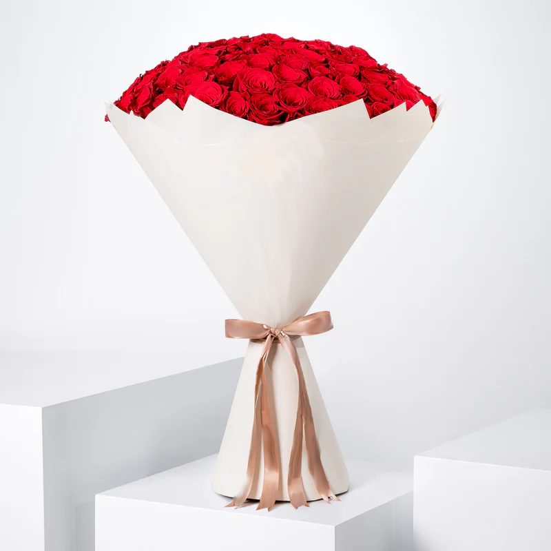100 red roses bouquet - Bloom Marbella, Spain wrapped in elegant white paper with a beige ribbon