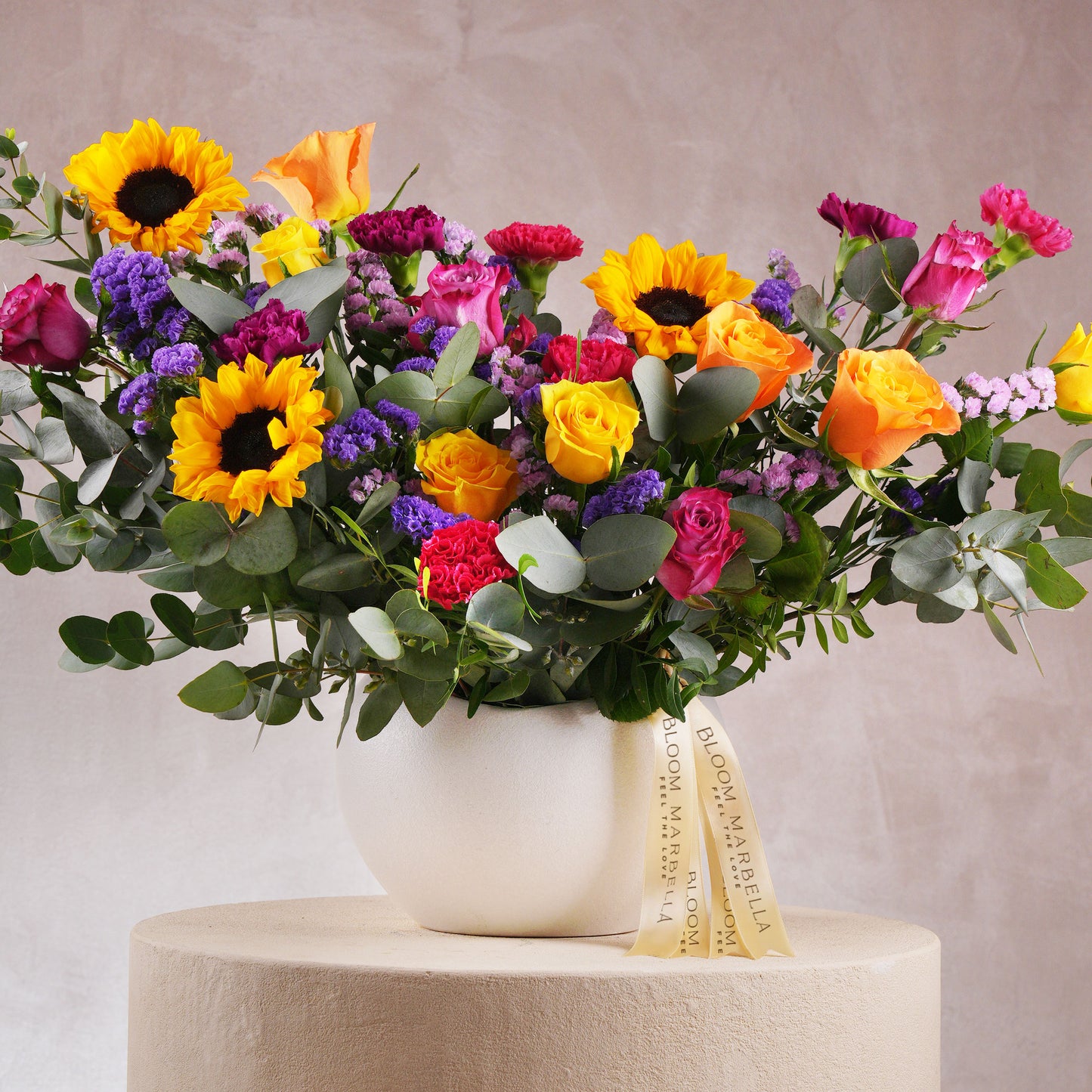 Vibrant floral arrangement Costa del Sol Marbella Bloom Marbella with sunflowers, roses, and lush greenery in white vase