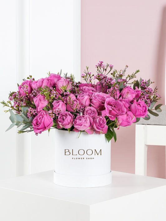 Misty Bubbles hatbox flowers by Bloom Marbella featuring vibrant pink roses and greenery in a white Bloom flower shop box