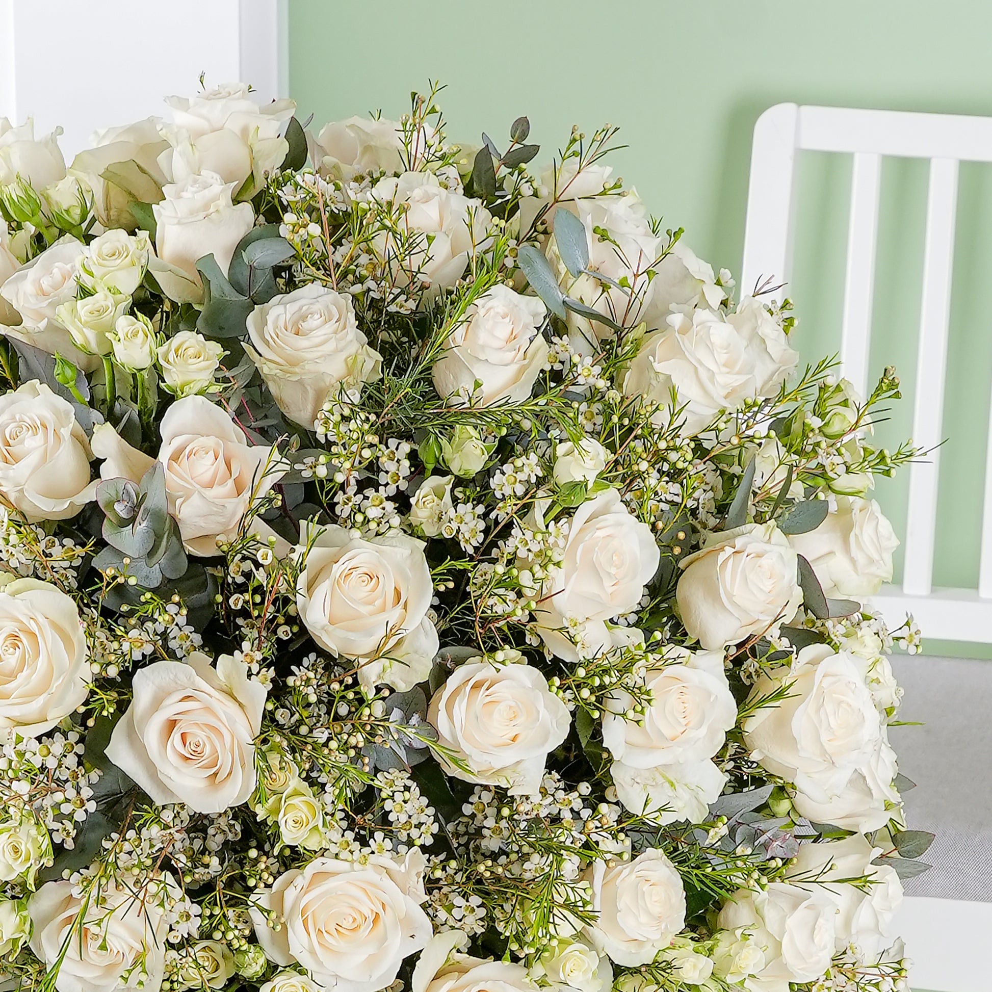 Close-up of white roses and greenery in the white rose hatbox Marbella by Bloom Marbella
