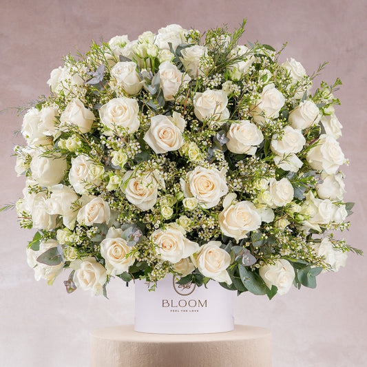 White rose hatbox Marbella with lush white roses and greenery by Bloom Marbella