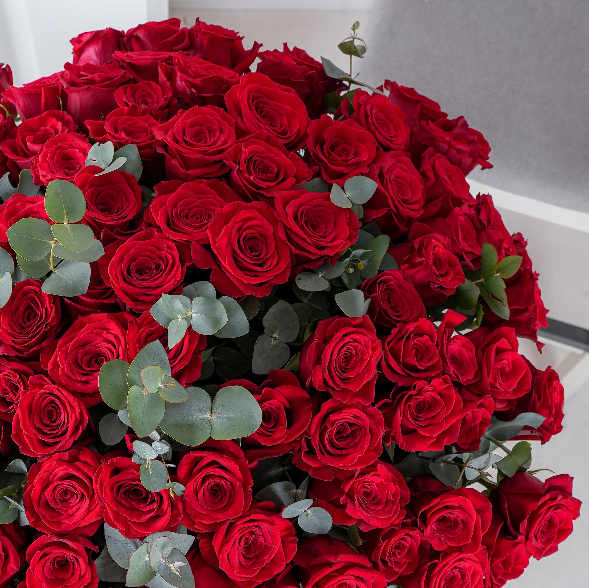 Bloom Marbella 200 red roses bouquet delivery with lush green foliage in a large elegant arrangement