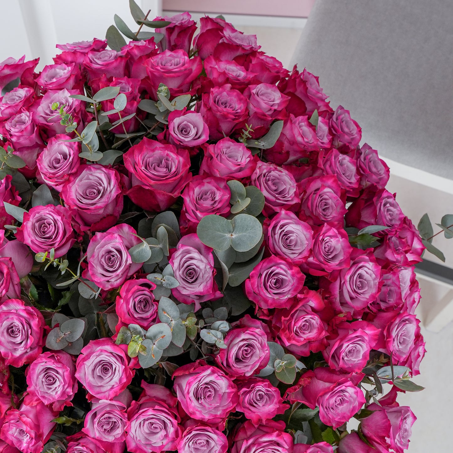 Large bouquet of vibrant pink roses with eucalyptus greenery from Bloom Marbella