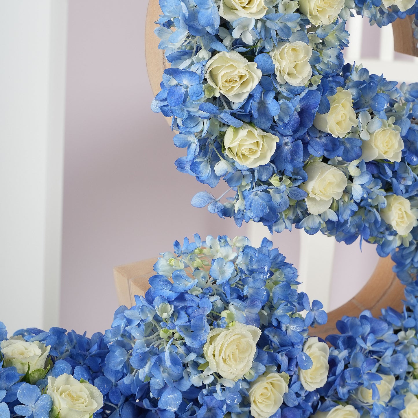 Deluxe letter flower arrangements featuring blue hydrangeas and white roses by Bloom Marbella