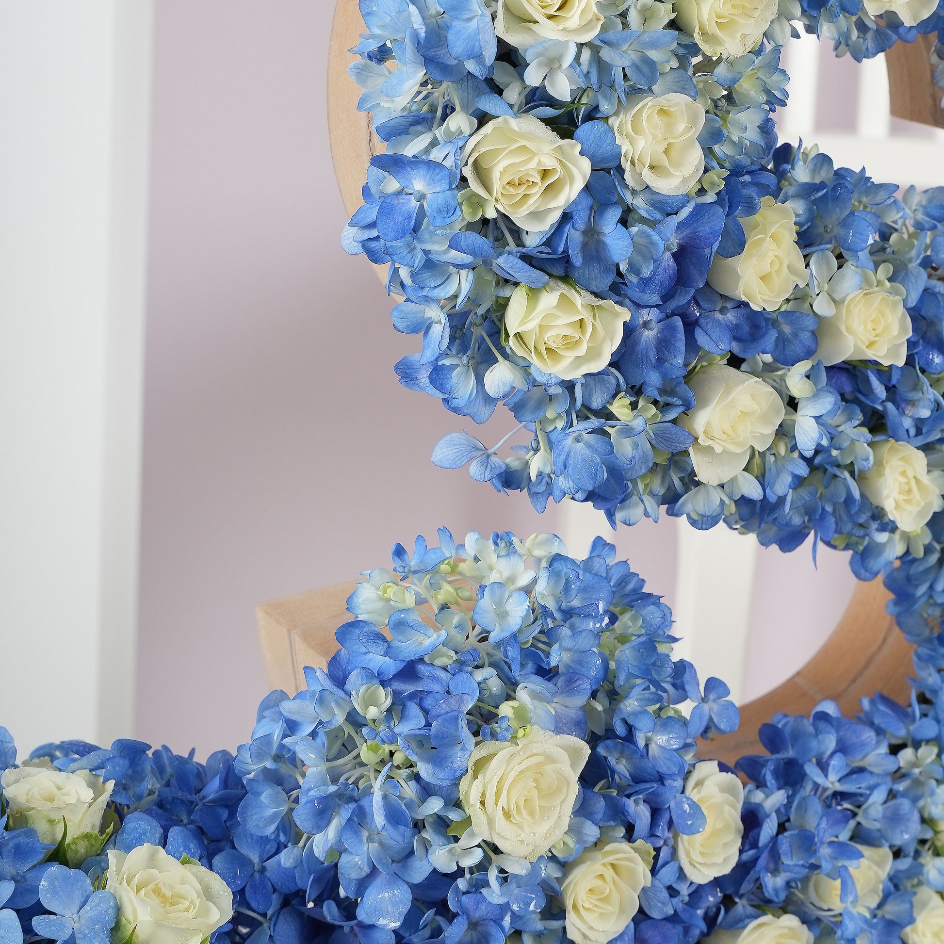 Deluxe letter flower arrangements featuring blue hydrangeas and white roses by Bloom Marbella