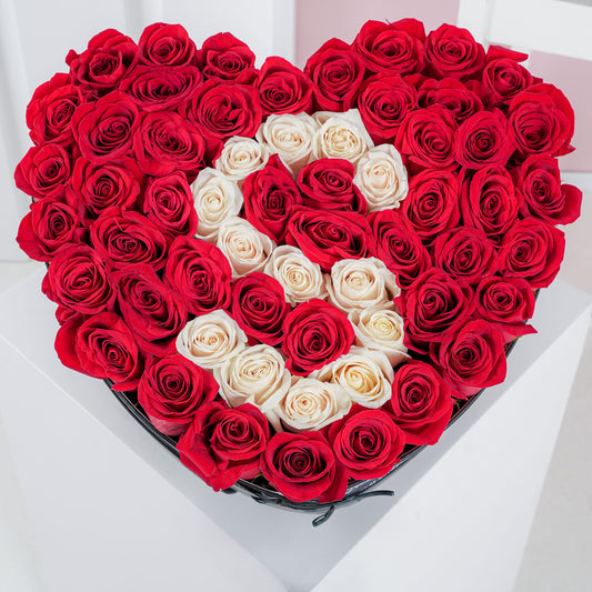 Heart shaped rose arrangement with red and white roses forming an elegant design by Bloom Marbella