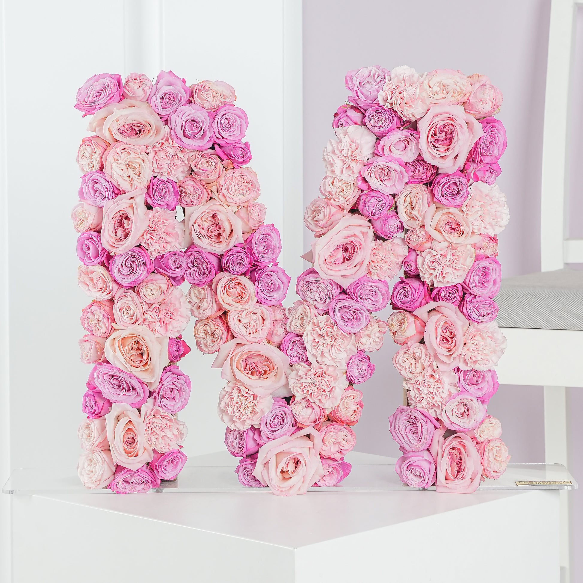 Pink and purple letter flower arrangement shaped as the letter M by Bloom Marbella