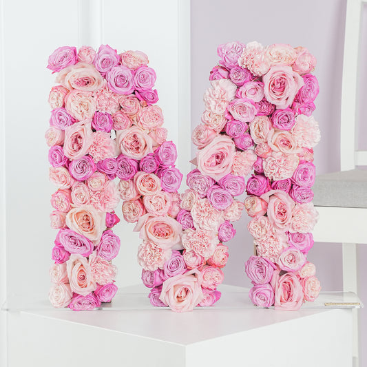 Pink and purple letter flower arrangement shaped as the letter M by Bloom Marbella