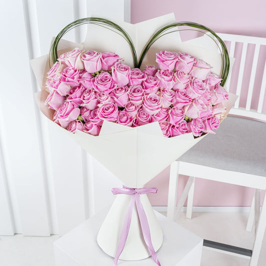 Luxury pink rose bouquet Marbella arranged in heart shape with white wrapping and pink ribbon
