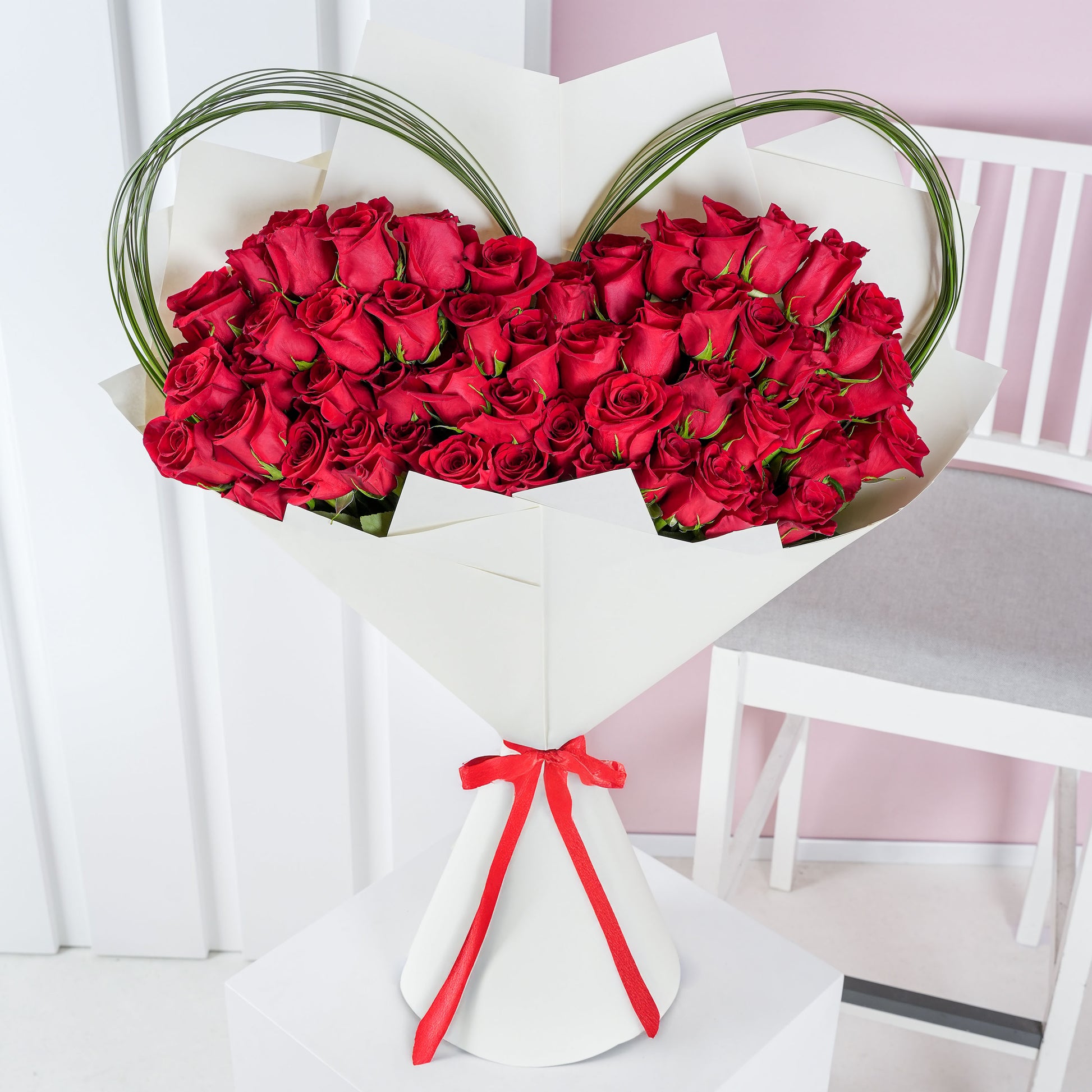Bloom Marbella luxury red rose bouquet Marbella wrapped in white paper with decorative greenery