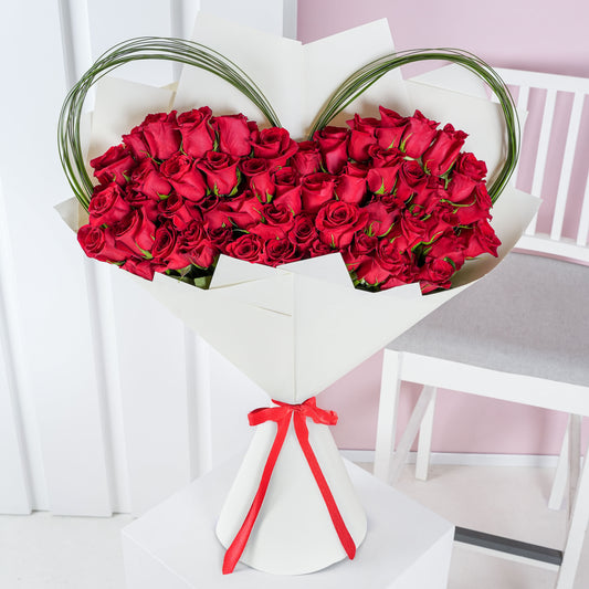 Bloom Marbella luxury red rose bouquet Marbella wrapped in white paper with decorative greenery