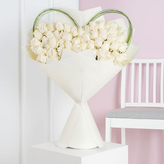 Luxury white rose bouquet Marbella arranged with fresh white roses wrapped in white paper by Bloom Marbella