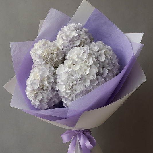 Purple hydrangea bouquet Marbella wrapped in purple and white paper with matching ribbon by Bloom Marbella